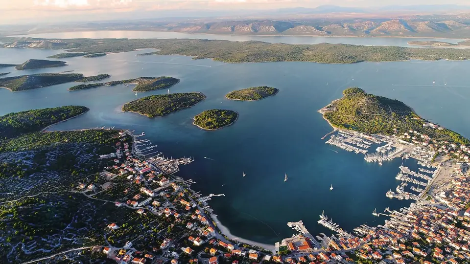 Murter town and its marina from the air, with the islands of the archipelago stretching out towards the Kornati
